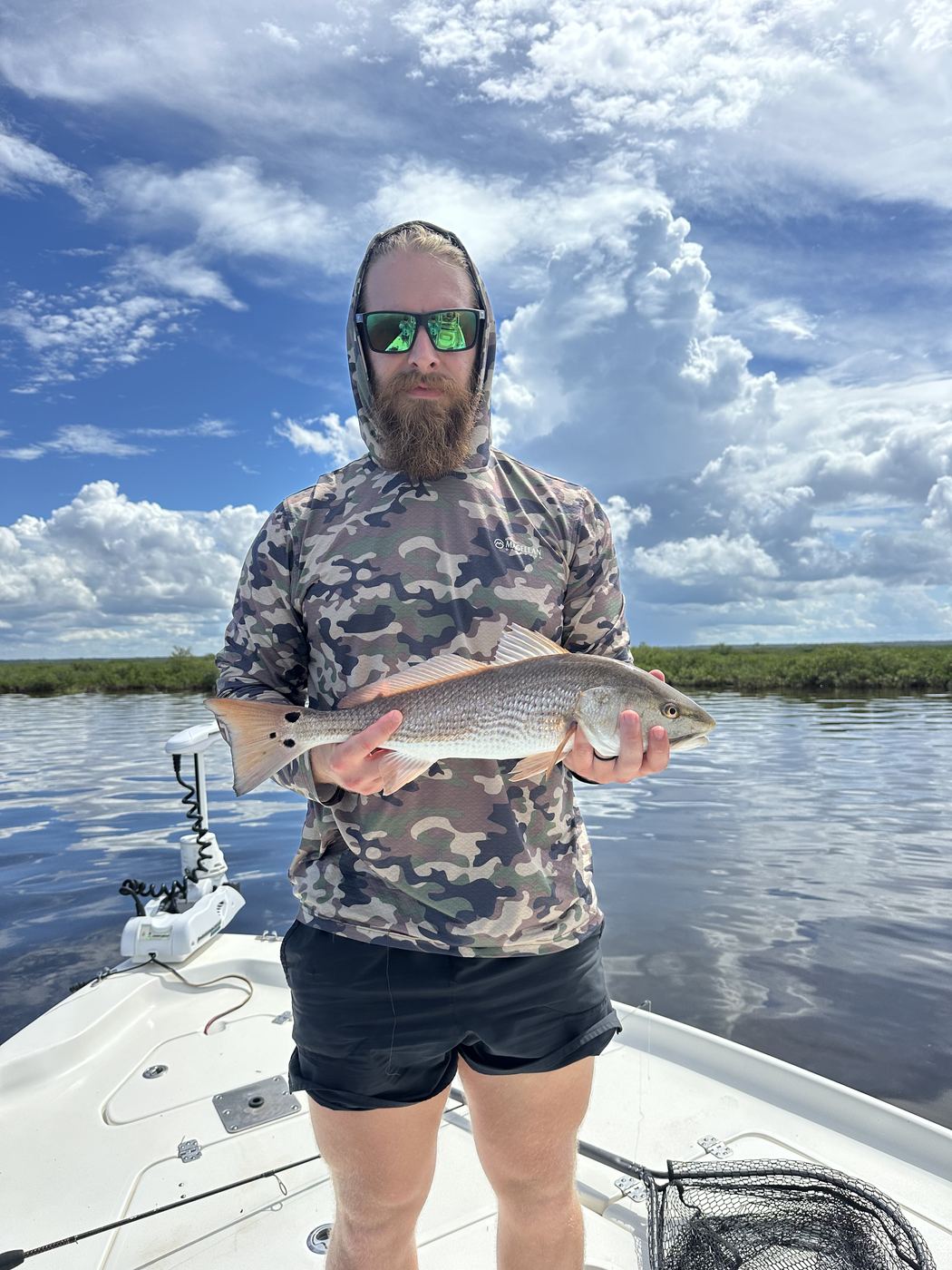 Andrew with a redfish on the water